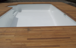 cap 9 - old marblesheen line pool recoated with white new tiles and a new timber deck