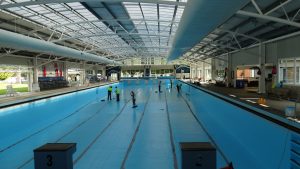 Poolpainters team resurfacing Olympic pool undercover